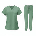 Green medical uniform set with top and pants on a white background