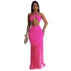 Woman wearing a bright pink dress with fringe details on a white background