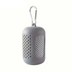 Light gray portable speaker with a carabiner on a white background