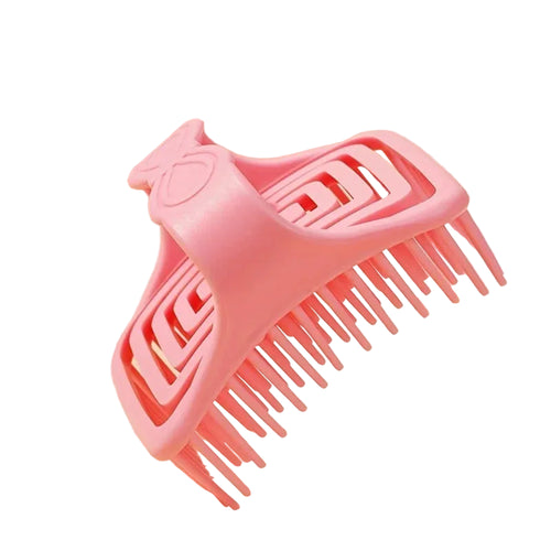 Pink scalp massage cleaning tool with text on a beige background