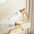 Estée Lauder skincare products on a gold and clear shelf