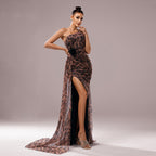 Woman wearing a leopard print evening gown with a high slit on a plain background