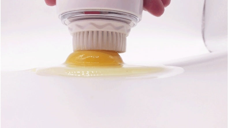 Egg separator being used to separate egg yolks from whites on a white background