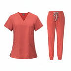 Coral medical uniform set with top and pants on a white background