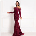 Woman wearing a burgundy off-shoulder sequin gown against a white background