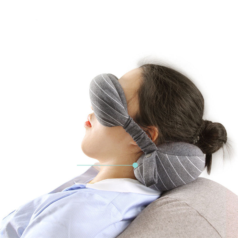 Person using a gray neck pillow with a close-up of a spine illustration on a white background