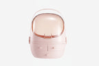 A pink waterproof cosmetic storage box displaying skincare bottles inside against a warm lighted background