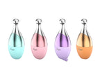 Four colorful bottles with metallic caps on a light purple background