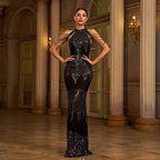 Woman in a black sequin gown standing in an elegant interior setting