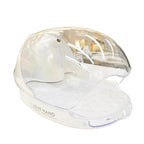 Clear plastic hand-shaped product on a white surface with a blurred background