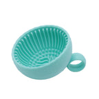 Green silicone strainer on a white background