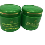 Two green jars with gold lids on a white background