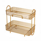 A luxury 2-tier transparent amber and light green cosmetic storage shelf with a gold iron frame, neatly holding various skincare bottles and perfumes.