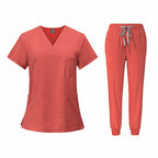Coral medical uniform set with top and pants on a white background
