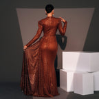Woman in a long, brown sequined dress standing against a dark background with white geometric shapes.