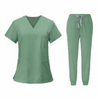 Green medical uniform set with top and pants on a white background