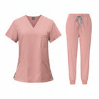 Pink medical uniform set with top and pants on a white background