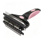 A pet grooming brush with a black and pink handle, featuring dual rows of metal teeth for detangling and shedding, shown on a plain white background.