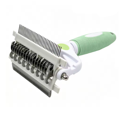 A pet grooming brush with a white plastic body, black metal bristles, and a light green ribbed handle, shown on a plain white background.