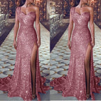 Pink sequin evening gown with a high slit on a patterned floor.