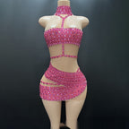 Mannequin wearing a pink beaded outfit against a dark background