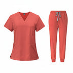 Coral medical uniform set with top and pants on a white background