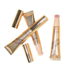 Makeup products including a lip gloss and applicators on a white background