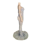 Mannequin wearing a sparkling silver evening gown on a white background