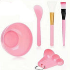 7-piece skincare tool kit with pink and white items on a white background