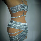 Silver sequin two-piece outfit on a mannequin against a gray background
