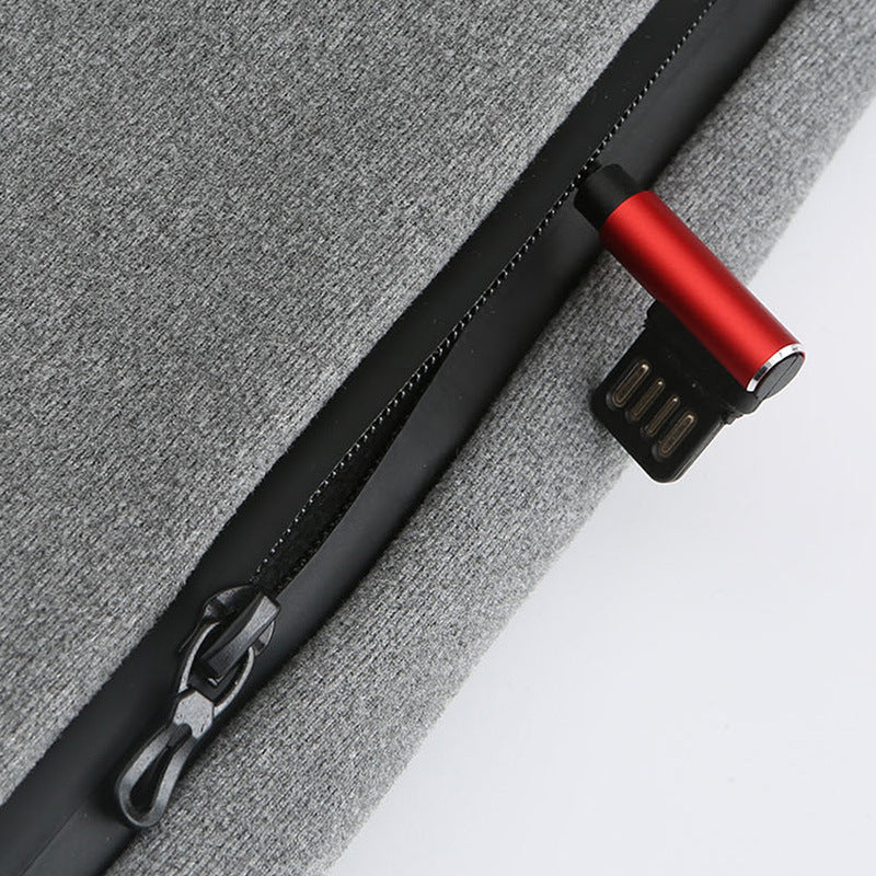 Red and black USB-C cable attached to a gray fabric surface