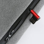 Red and black USB-C cable attached to a gray fabric surface