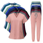 Stack of pink scrub tops and pants with color swatches on a white background