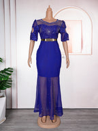 Blue evening gown on a mannequin against a white wall.