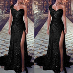 Black sequin evening gown with a high slit on a patterned floor background