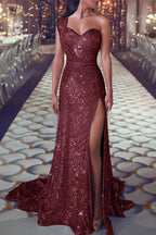 Red sequin evening gown with a high slit on a patterned floor.