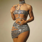 Silver sequin outfit on a plain background