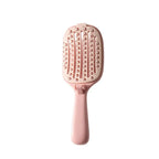 Pink hair brush with measurements on a white background