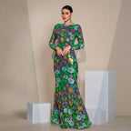 Woman wearing a long floral dress against a beige background