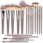 Set of makeup brushes with brown and silver handles on a white background