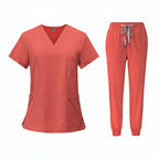 Coral medical uniform set with top and pants on a white background