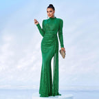 Woman in a green evening gown on a light blue background