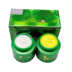 Two green jars with cream and a green box on a white background