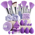 Makeup brushes, sponges, and a towel on a light purple background