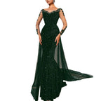 Green evening gown with intricate detailing on a white background