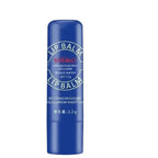 Two blue lip balms with packaging on a light gray background