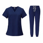 Navy blue medical uniform set with top and pants on a white background