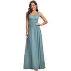 Woman wearing a long teal dress on a white background