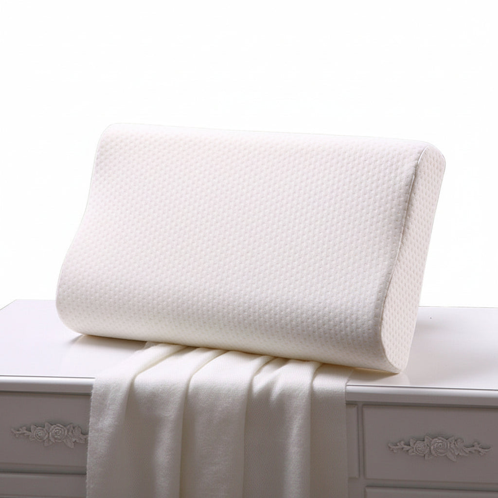 An ergonomic white slow rebound memory foam cervical spine space pillow resting on a bed