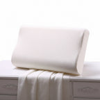 An ergonomic white slow rebound memory foam cervical spine space pillow resting on a bed